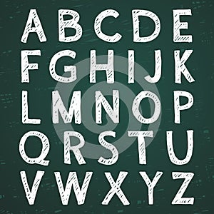 Hand-drawn alphabet. Calligraphy font. Modern chalk lettering. Letters on the green board
