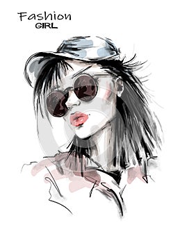 Hand drawn beautiful young woman in cap. Stylish girl in sunglasses. Fashion woman look. Sketch.