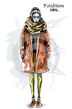 Hand drawn beautiful young woman in coat. Stylish girl in sunglasses. Fashion woman look. Winter outfit.