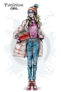 Hand drawn beautiful young woman with gift box. Stylish girl winter outfit. Fashion woman look.