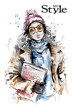 Hand drawn beautiful young woman holding fashion magazine. Stylish girl in knit cap. Fashion woman winter look.