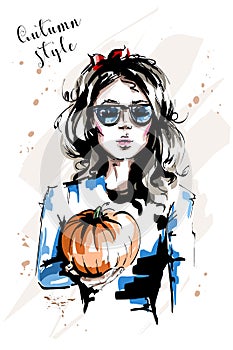 Hand drawn beautiful young woman holding pumpkin. Stylish elegant girl with red bow in her hair. Fashion woman in sunglasses.