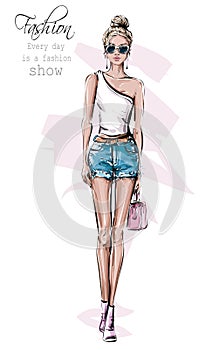 Hand drawn beautiful young woman in sunglasses. Fashion female outfit. Stylish girl in jeans shorts. Fashion woman look. Sketch.