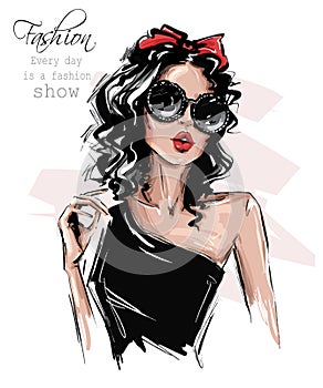 Hand drawn beautiful young woman in sunglasses. Stylish girl with bow on her head. Fashion woman look. Sketch.