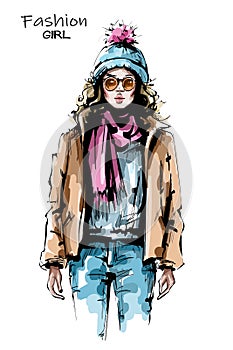 Hand drawn beautiful young woman in sunglasses. Stylish girl in winter clothes. Fashion woman look. Sketch. Vector illustration.