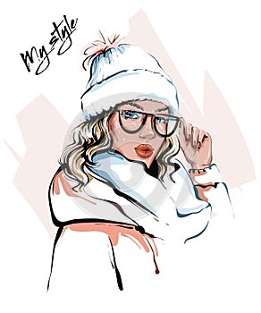 Hand drawn beautiful young woman in winter clothes. Stylish girl. Fashion woman look. Sketch.