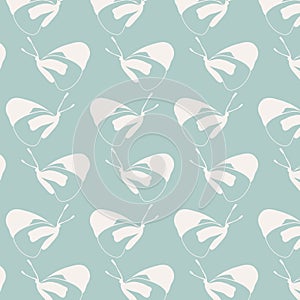 Hand drawn butterflies pattern in creamy white color on jade greenbackground.