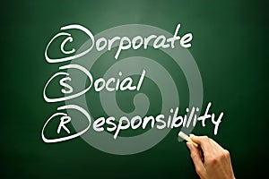 Hand drawn Corporate Social Responsibility (CSR), business concept acronym on blackboard