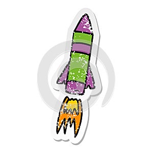 hand drawn distressed sticker cartoon doodle of a space rocket