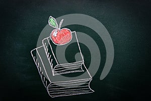 Hand Drawn Doodle Illustration with Chalk on Blackboard of Stack Pile of Books Red Glossy Apple on Top. Back to School Education