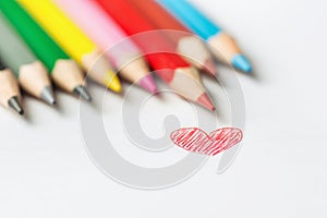 Hand Drawn Doodle Red Heart Photograph of Row of Multicolored Pencils on White Background. Valentine Mother`s Day Kids Charity