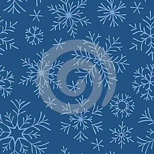 Hand drawn doodle seamless pattern. Blue snowflakes on a dark background. For fabric, textile, wrapping paper, card, invitation,