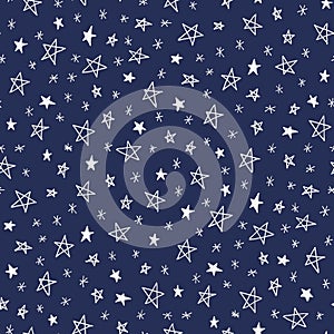 Hand drawn doodle stars on dark blue sky vector seamless pattern. Winter Christmas cute holiday background.