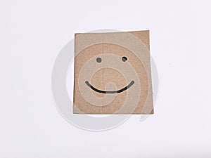Hand drawn happy face on brown paper. Positive attitude concept.