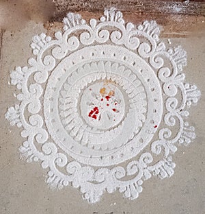 Hand drawn Indian Traditional and Cultural Rangoli, Alpona, Kolam or paisley with white rice powder
