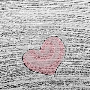 Hand drawn red heart as a symbol of love and valentines day on stroked pencil drawn background