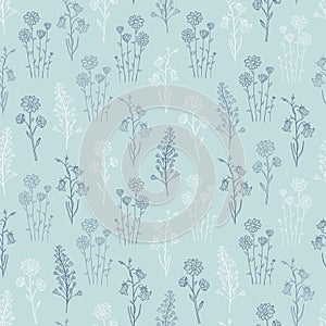 Hand drawn seamless pattern of blooming wildflowers, canterbury bells, chamomile. Floral collection on a blue background.