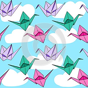 Hand drawn seamless pattern with japanese origami paper crames birds on blue sky white clouds background. Pink purple