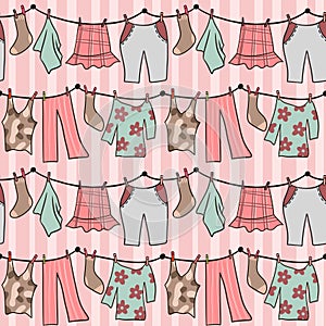 Hand drawn seamless pattern with pink pastel laundry clothesline hanging clothes. Dress pants socks on string line