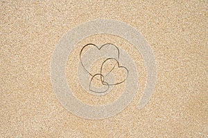 Hand-drawn shape of three heart on sand tropical beach. valentines day. Holiday, the vacation of family, friends concept. Creative