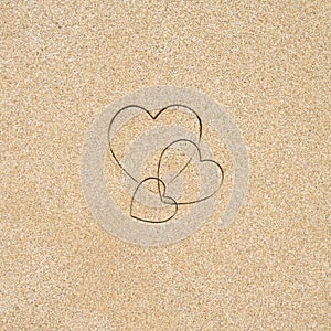 Hand-drawn shape of three heart on sand tropical beach. valentines day. Holiday, the vacation of family, friends concept. Creative