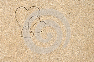 Hand-drawn shape of three heart on sand tropical beach. valentines day. Holiday, the vacation of family, friends concept. Creative