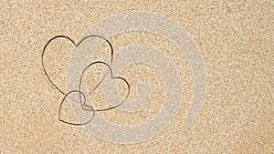 Hand-drawn shape of three heart on sand tropical beach. valentines day. Holiday, the vacation of family, friends concept. Creative