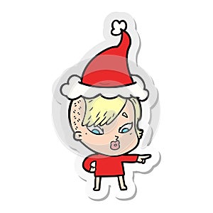 hand drawn sticker cartoon of a surprised girl pointing wearing santa hat