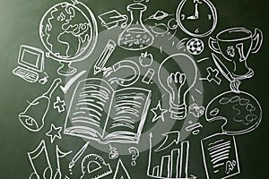 Hand drawn symbols of school subjects on a chalkboard photo