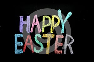 Hand drawn text `Happy Easter` on chalkboard