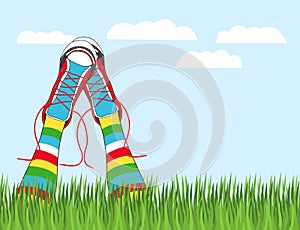 Hand drawn vector illustration his feet in sneakers and multicolored striped stockings sticking out of the grass