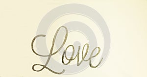 Hand drawn wrote in silver sign for LOVE on a white background photo
