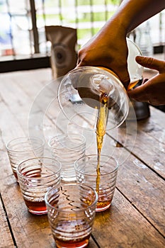 Hand drip coffee , Barista pouring coffee into cups, vintage style