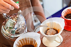 Hand drip coffee, Barista pouring water on coffee ground with filter