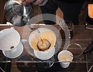 Hand drip coffee Barista pouring water on coffee ground with filter