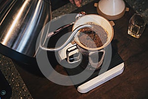 Hand drip coffee Barista pouring water on coffee ground with filter