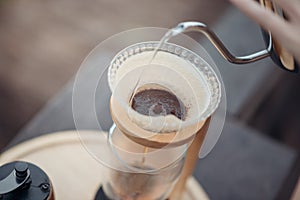 Hand drip coffee, Barista pouring water on the coffee ground with filter