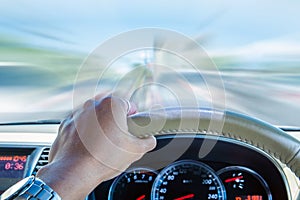 Hand of driver holding steering wheel, driving fast speed motion