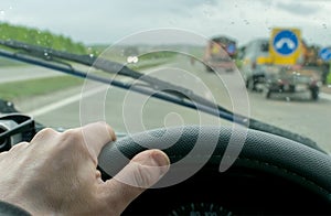 Hand driver on the steering wheel of the car