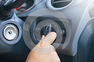 Hand driver turn on light switch in car