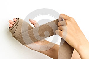 Hand with an elastic bandage isolated over white back ground