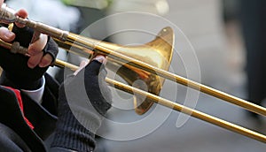 Hand of elderly man with gloves playing the trumpet