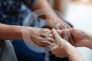 Hand of elderly woman holding hand younger woman, Helping hands, take care for the elderly concept