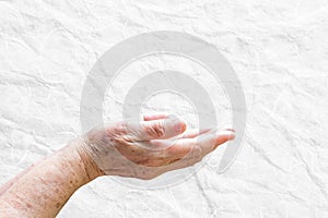 Hand elderly woman open up on white background.