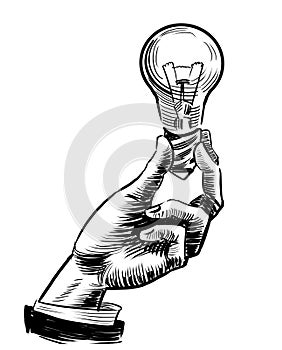 Hand with an electric bulb