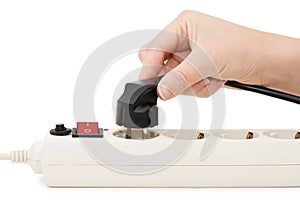 Hand with an electric plug and socket