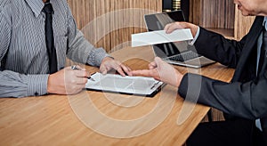 Hand of employer filing final remuneration after employee to write a document letter of resignation, resign concept