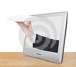 Hand with empty white plate leans out TV screen