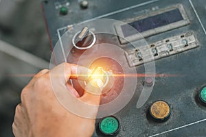 Hand of engineer turn power button machine.