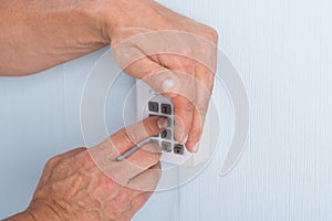 Hand entering pin in security system